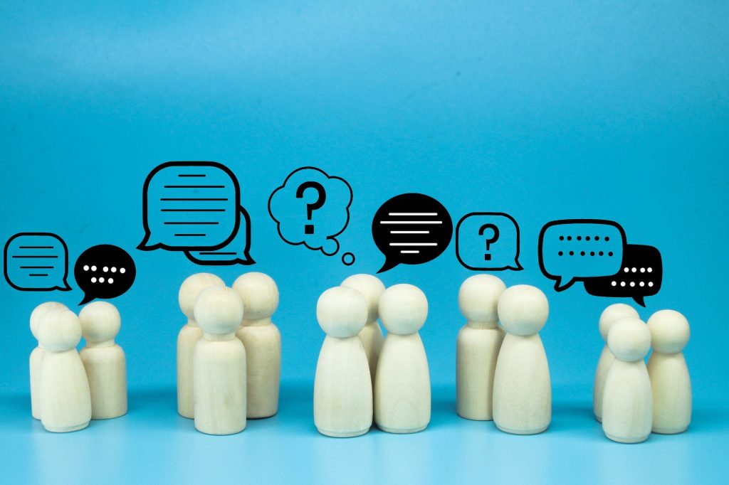 peg doll with message notification icon, chat social media interaction.